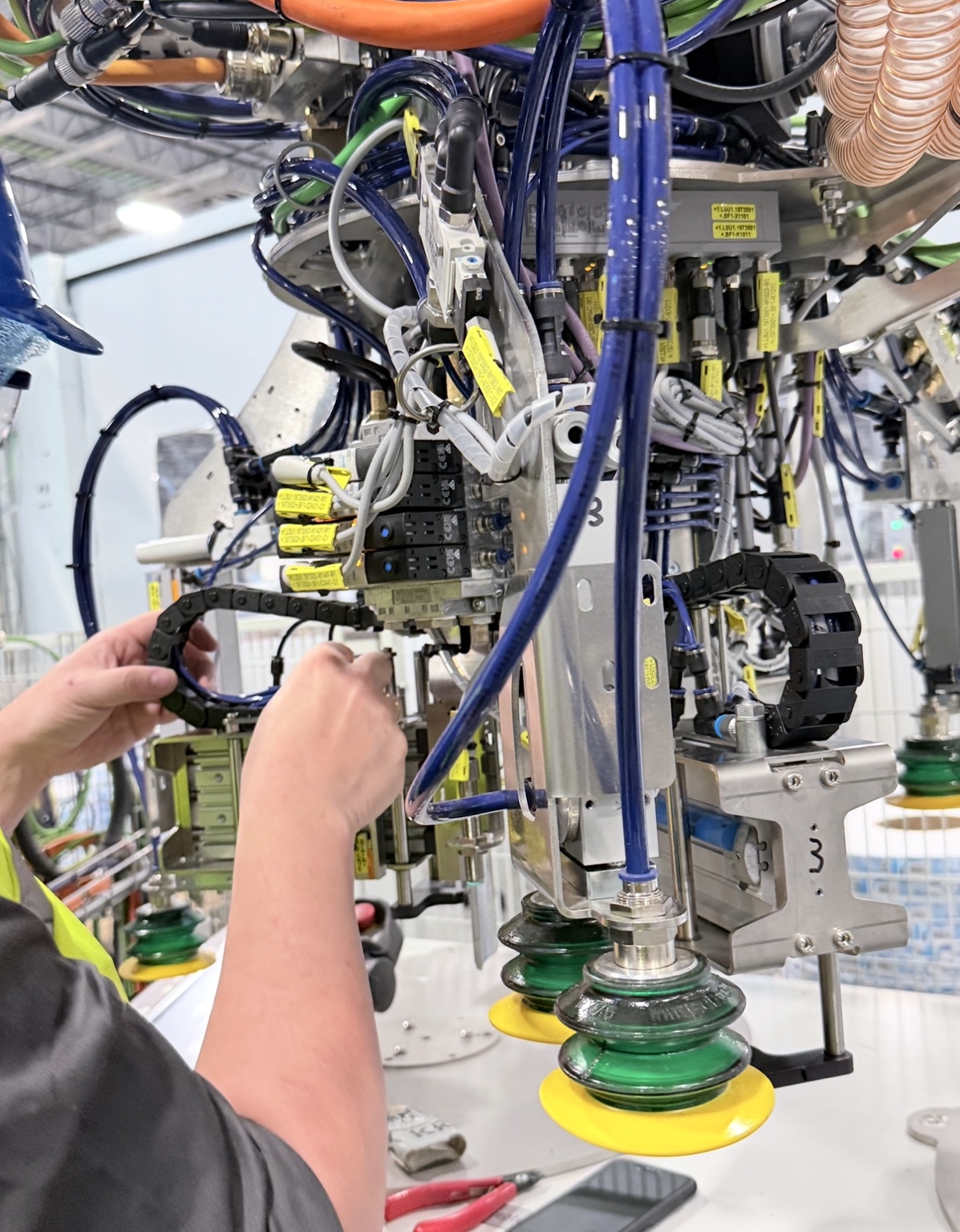 Industrial gripper assembly with pneumatic hoses and tooling