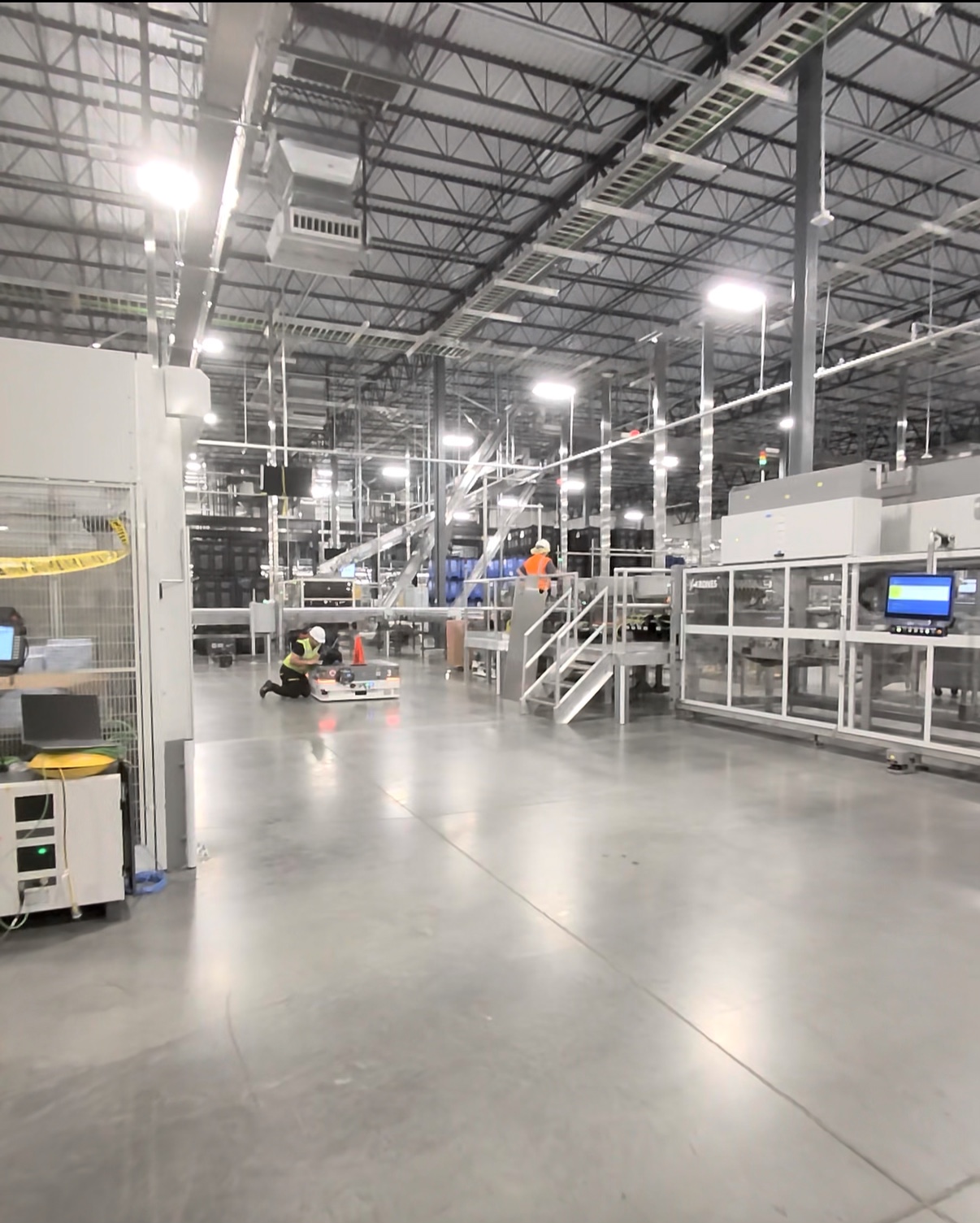 Industrial production floor with guarded equipment and operator interfaces